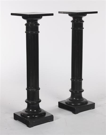 Appraisal: A pair of ebonised pedestal columns each with a square