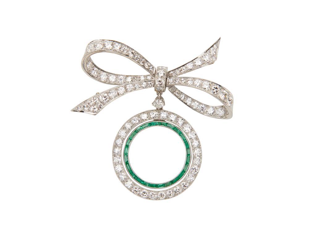 Appraisal: Platinum Diamond and Emerald Brooch the bow-form diamond-set brooch suspending