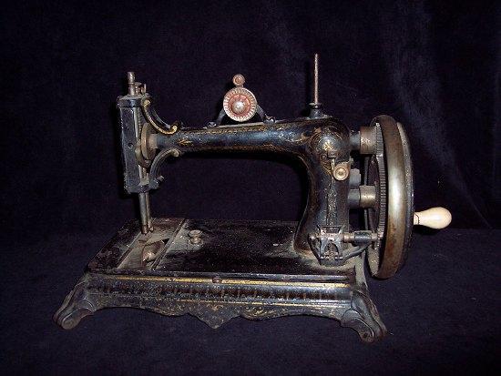 Appraisal: A sewing machine with ivorine handle on a rectangular base