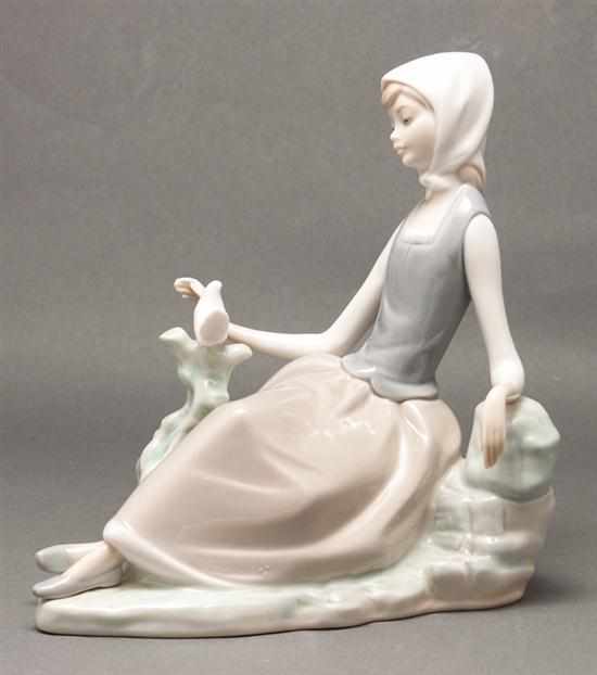 Appraisal: Lladro porcelain figure of a seated girl with dove on