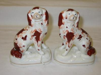 Appraisal: A PAIR OF STAFFORDSHIRE PORCELAIN DOGS modelled as seated spaniels