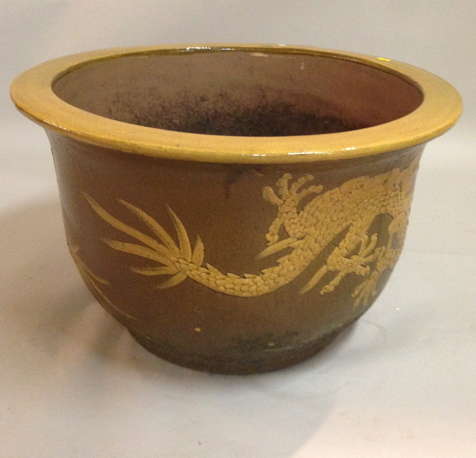 Appraisal: A thC Chinese jardiniere decorated with a raised dragon on