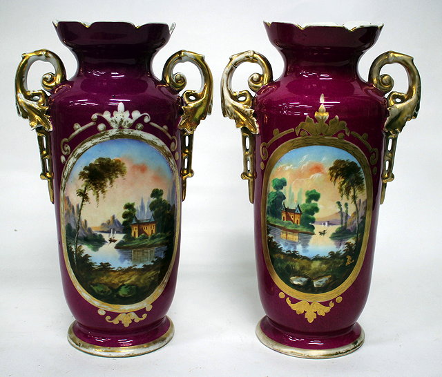 Appraisal: A PAIR OF CONTINENTAL PORCELAIN PUCE GROUND VASES each decorated