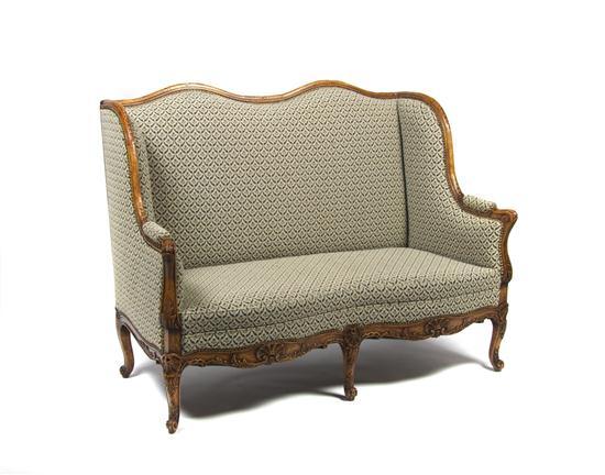 Appraisal: French Provincial Style Wingback Settee having upholstered back arms and