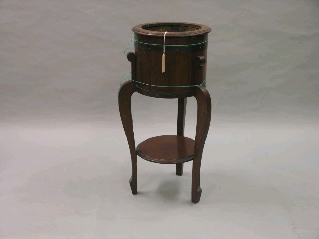 Appraisal: A copper bound mahogany jardiniere stand circular shape on three