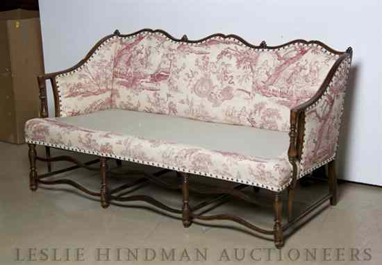 Appraisal: An American Upholstered Settee having a shaped crest over the