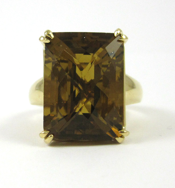 Appraisal: FOURTEEN KARAT GOLD AND TOPAZ RING rectangular checkerboard cut cognac