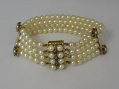 Appraisal: A CULTURED PEARL AND GARNET BRACELET comprising four uniform strands