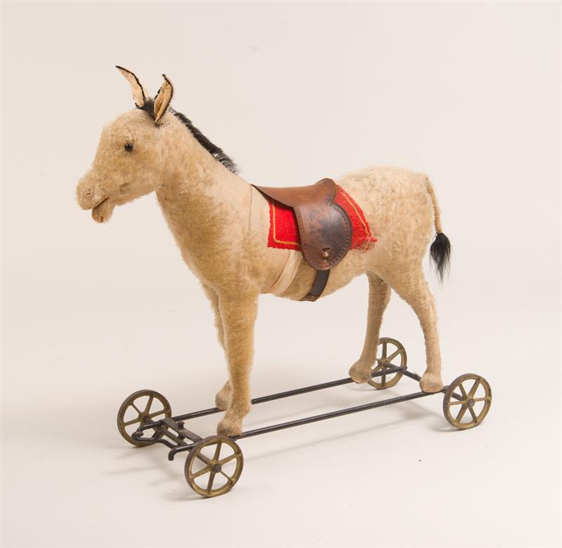 Appraisal: STEIFF CHILD'S DONKEY-FORM PULL TOY With original leather saddle c