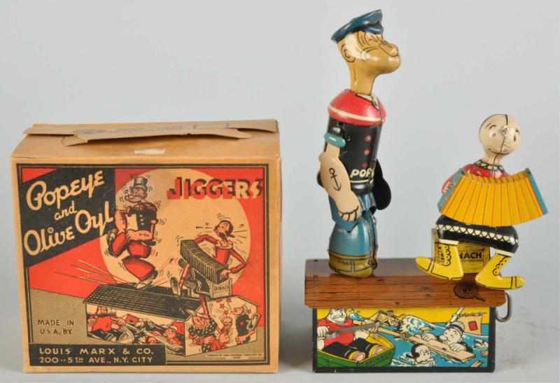 Appraisal: Tin Marx Popeye Olive Oyl Jiggers Wind-Up Toy Description American