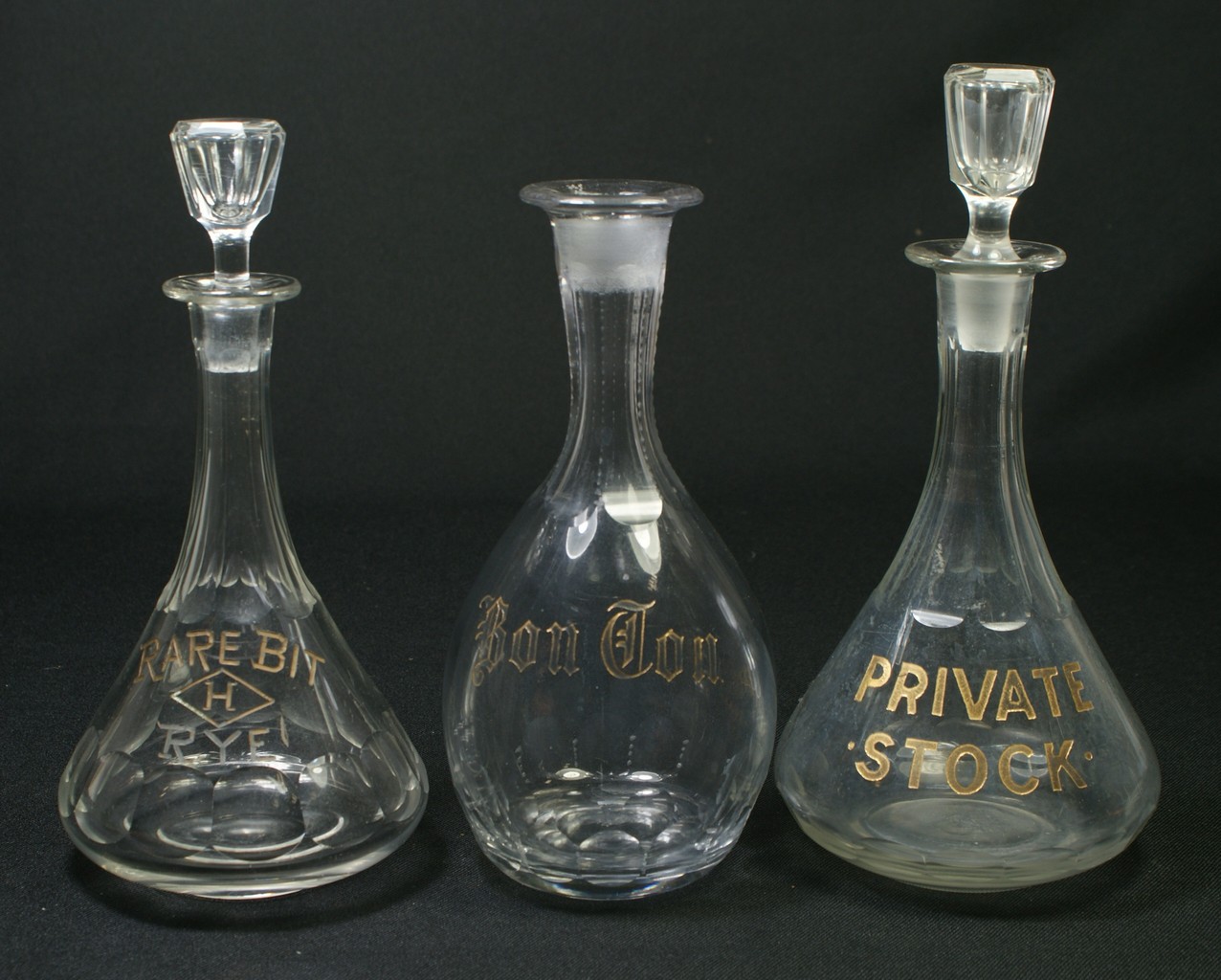 Appraisal: clear glass back bar bottles with etched and gilt decoration