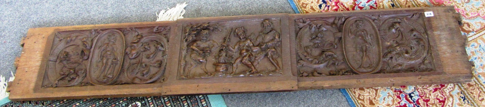 Appraisal: A large th century carved oak panel centred by a