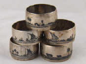 Appraisal: Five white metal tests silver napkin rings with niello scenes