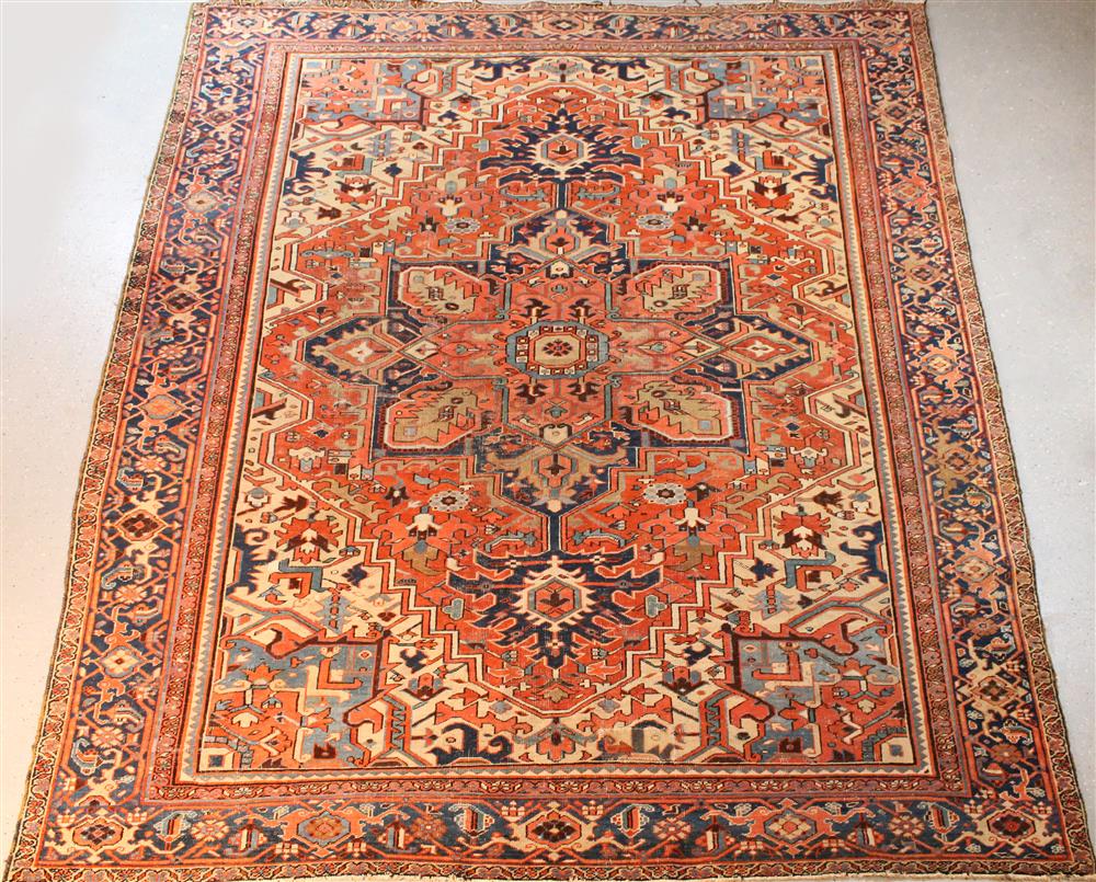 Appraisal: PERSIAN HERIZ RUG having primary colors of rust beige and