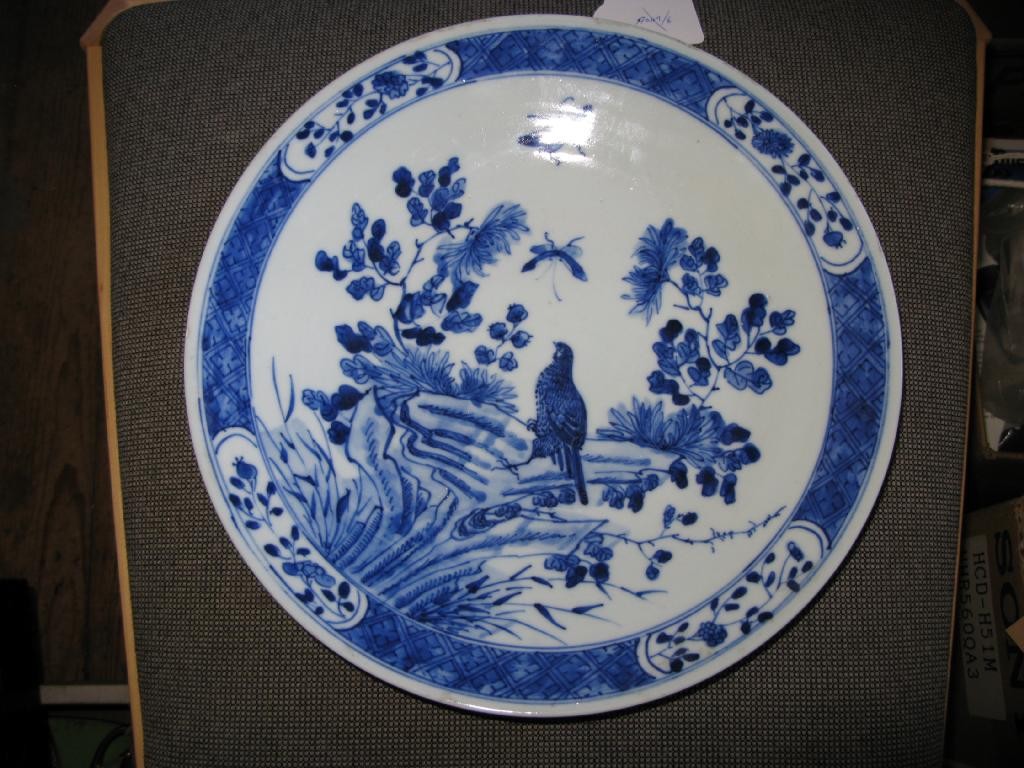 Appraisal: A Chinese wall plate painted with a bird and garden