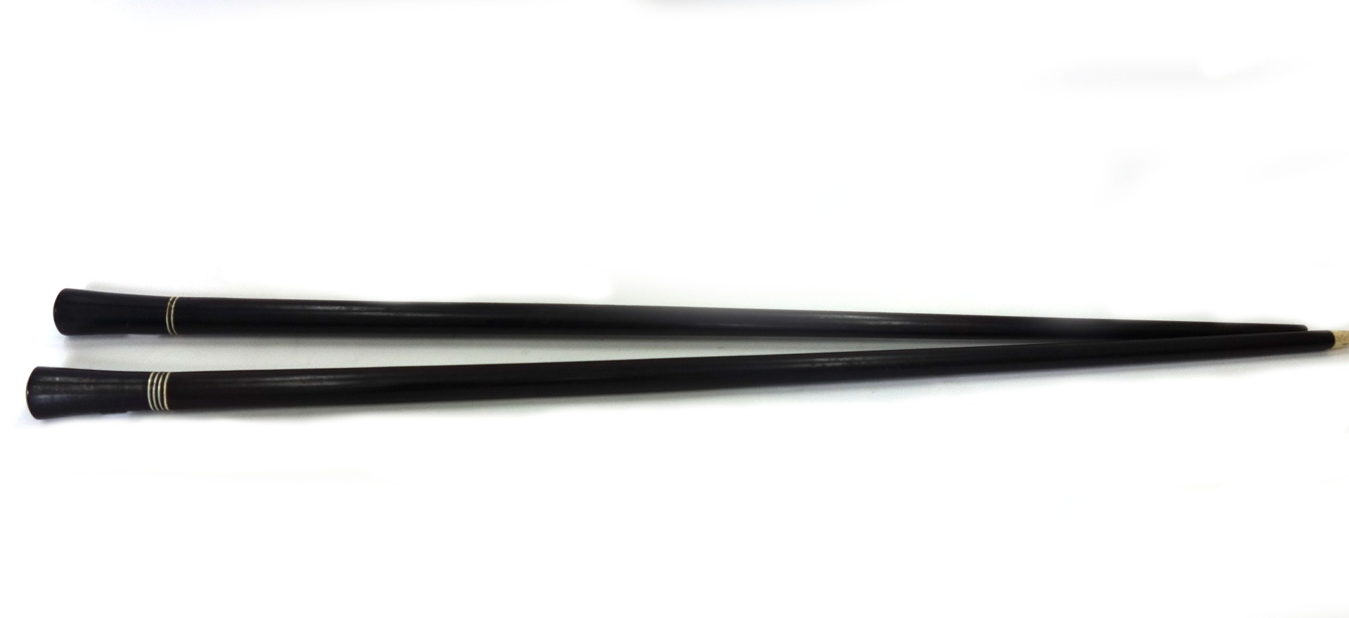 Appraisal: Two late th century ebony walking canes with narrow ivory