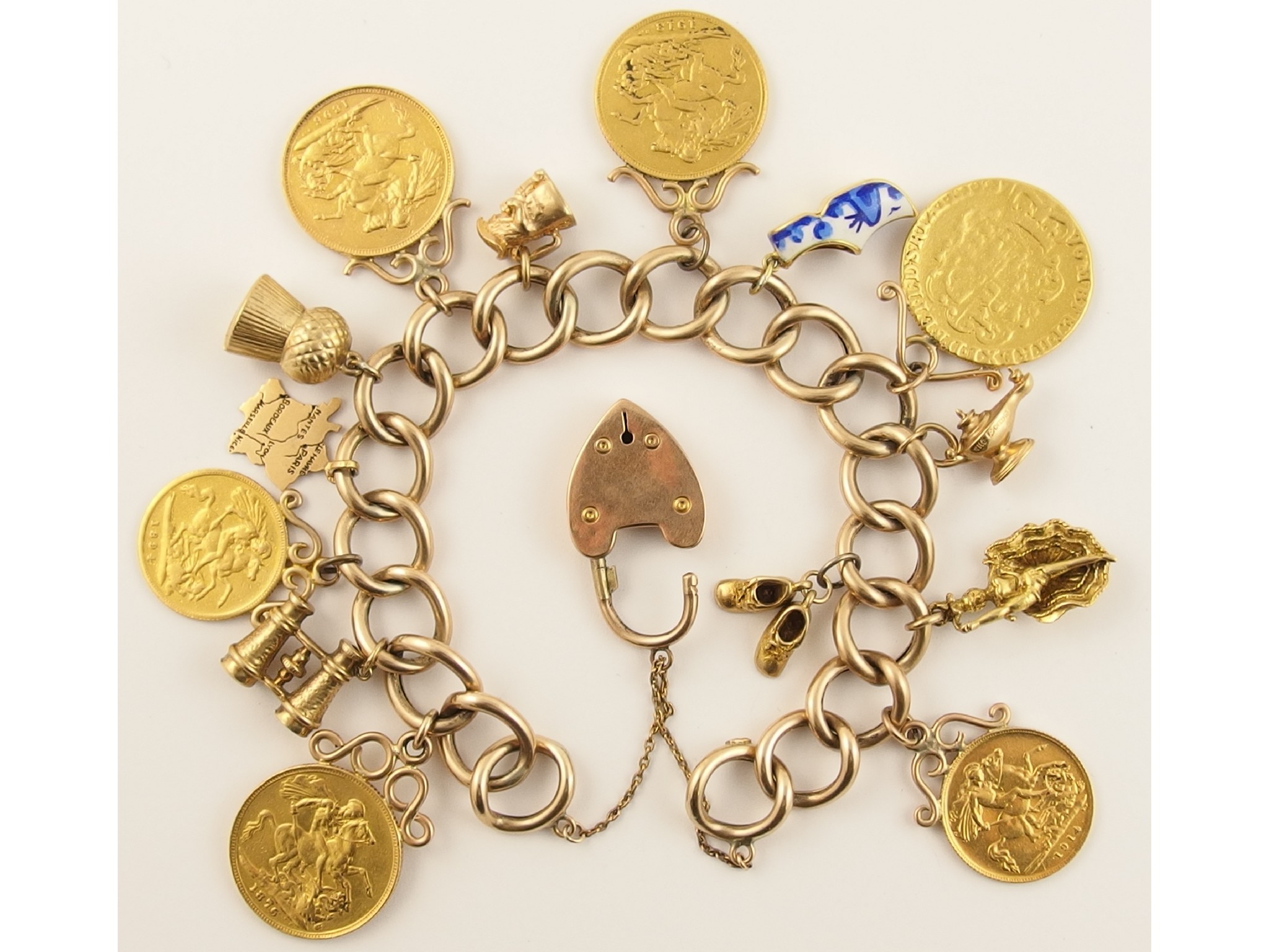 Appraisal: A ct gold charm bracelet hung with three full gold