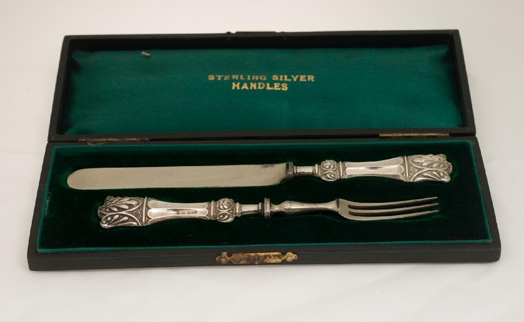 Appraisal: EDWARDIAN SILVER-HANDLED CHILDS KNIFE AND FORK BIRMINGHAM the fluted handles