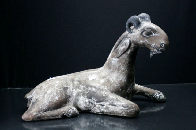 Appraisal: A carved seated goat late th century