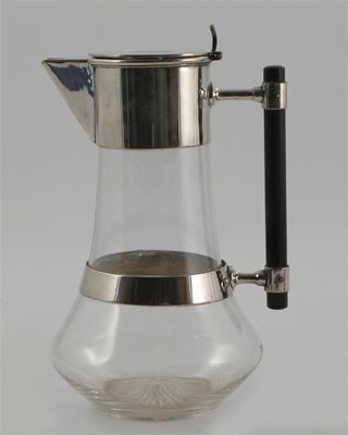 Appraisal: An electroplated metal and glass decanter from a design by