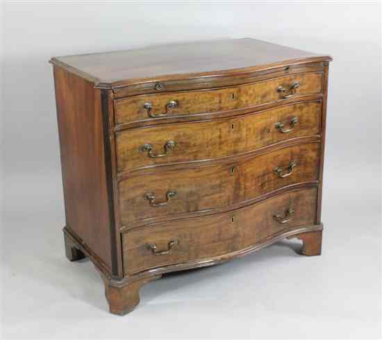 Appraisal: A George III mahogany serpentine chest with brushing slide above