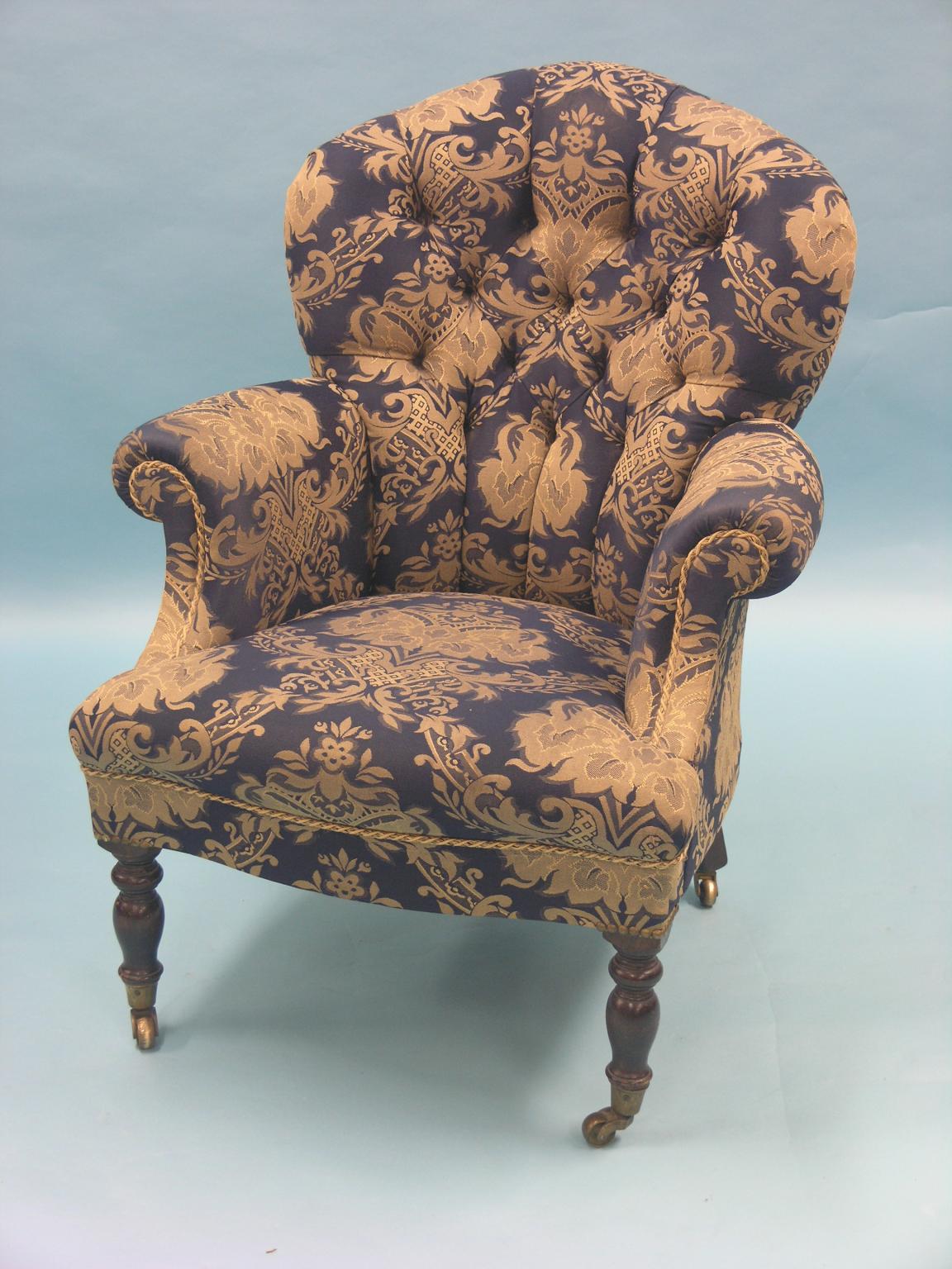 Appraisal: A Victorian drawing room armchair spoon-back upholstered in a buttoned