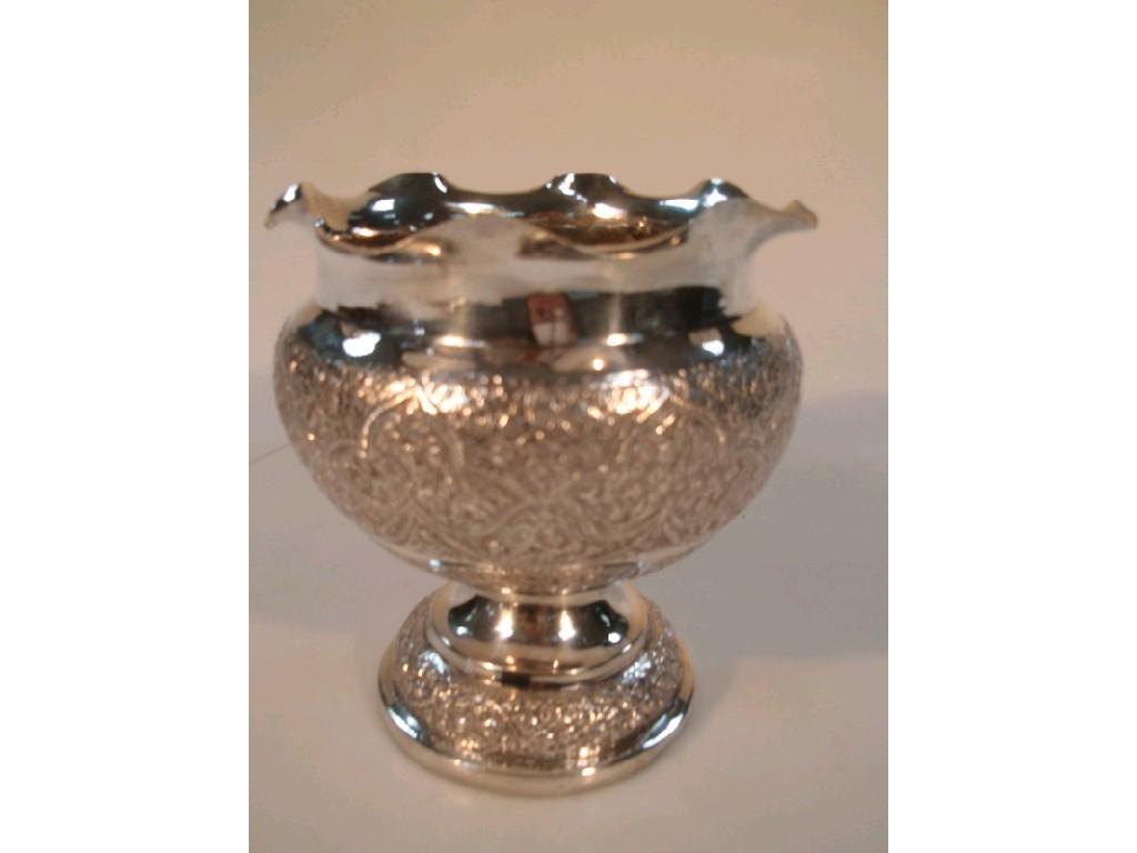 Appraisal: An Indian white metal pedestal bowl with a fluted rim