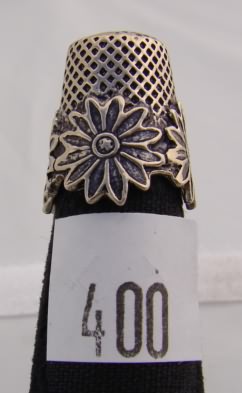 Appraisal: Silver tone thimble with floral scalloped band design