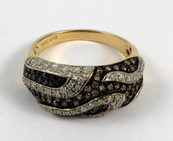 Appraisal: DIAMOND AND FOURTEEN KARAT GOLD RING set with round-cut champagne