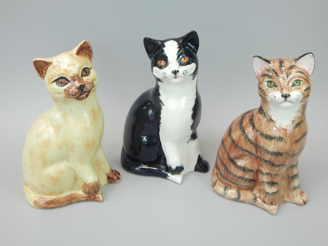 Appraisal: Three Price Kensington pottery cats black and white ginger the