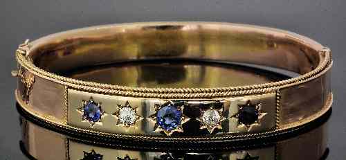 Appraisal: A Victorian gold metal mounted sapphire and diamond set stiff