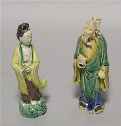 Appraisal: TWO CHINESE GLAZED BISCUIT FIGURES The first of Guanyin dressed