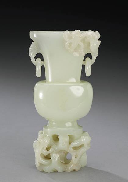 Appraisal: A carved white jade ring-handled vase th Century Of flattened