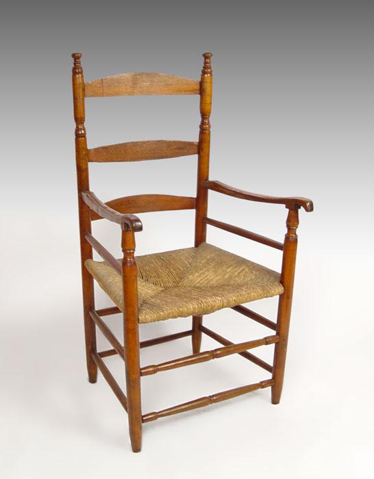 Appraisal: EARLY TH C LADDER BACK ARM CHAIR Wide rush seat