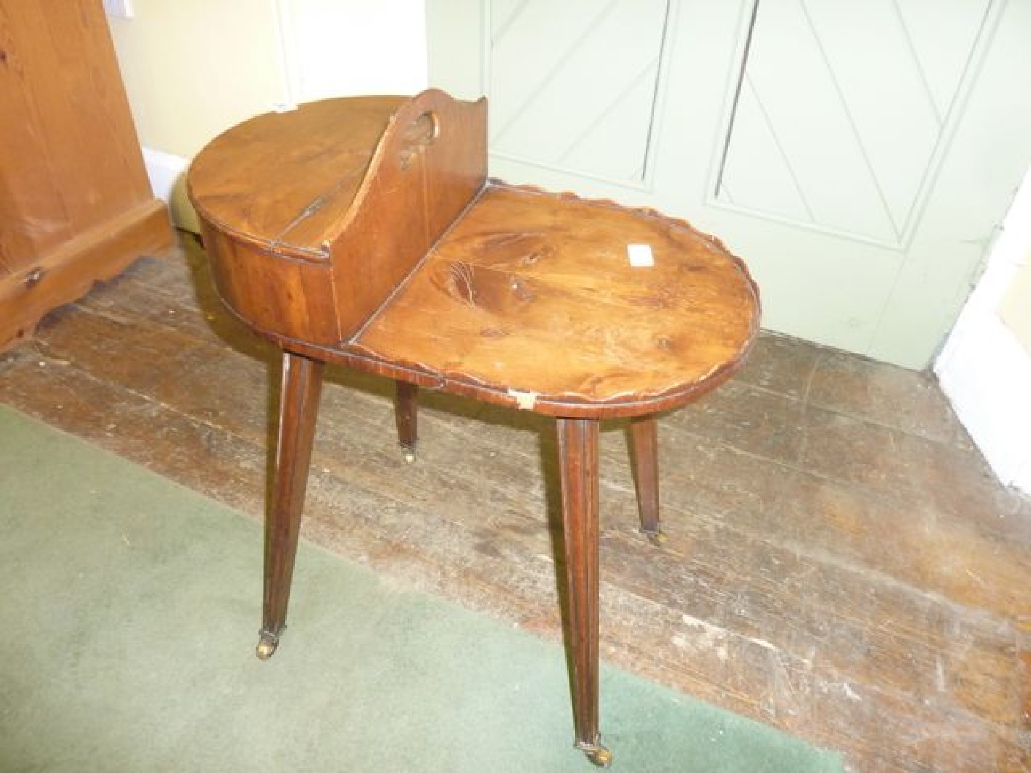 Appraisal: A Georgian style yew wood veneered butler's table of oval