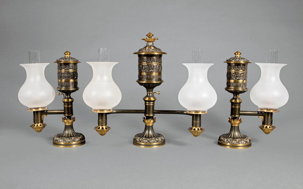 Appraisal: English Gilt and Patinated Bronze Three-Piece Argand Lamp Garniture th