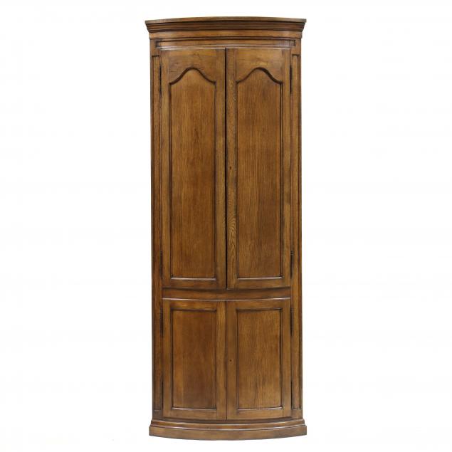 Appraisal: ENGLISH STYLE BOW-FRONT OAK CORNER CUPBOARD Mid- th century one