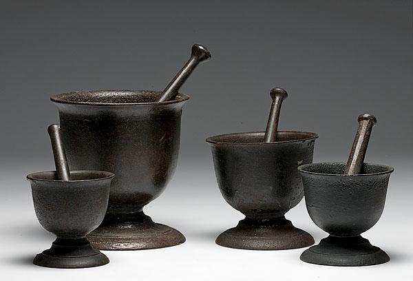 Appraisal: FOUR CAST IRON MORTARS AND PESTLES ranging in size from