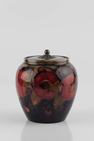 Appraisal: William Moorcroft British - 'Pomegranate' biscuit barrel and coverwith pewter