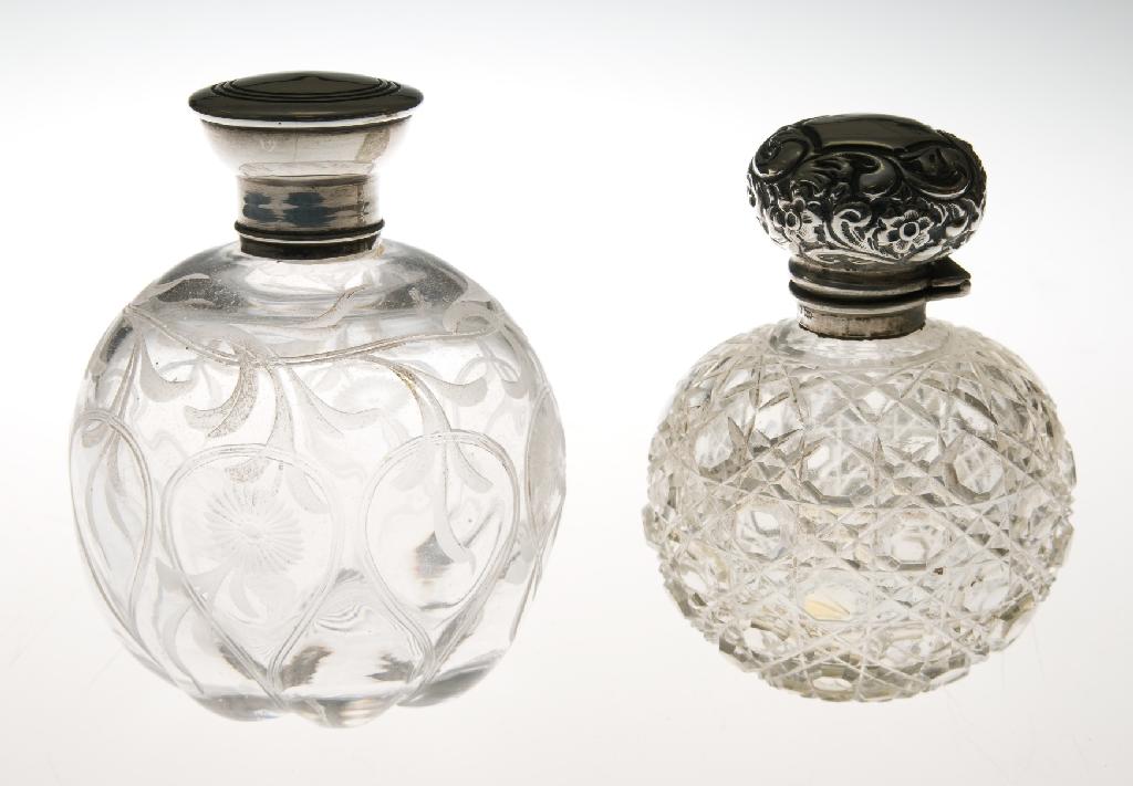 Appraisal: TWO SILVER-TOPPED GLASS SCENT BOTTLES the first with diamond cut