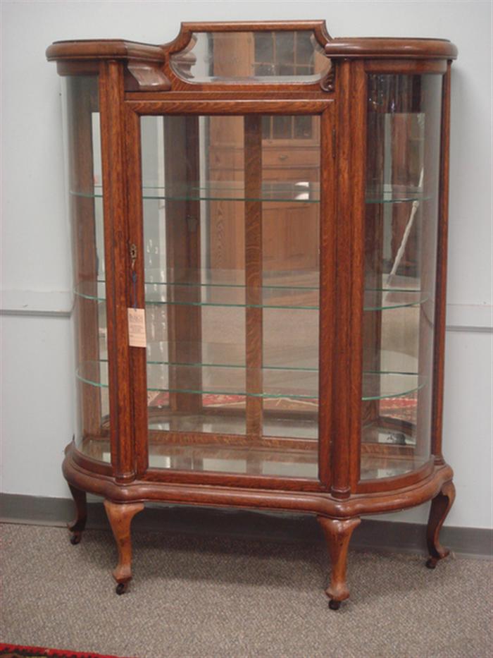 Appraisal: Oak mirror back bow glass front china cabinet with three