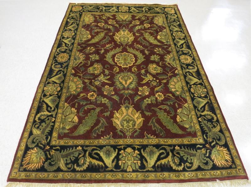 Appraisal: HAND KNOTTED ORIENTAL CARPET Indo-Persian overall foliate design on plum