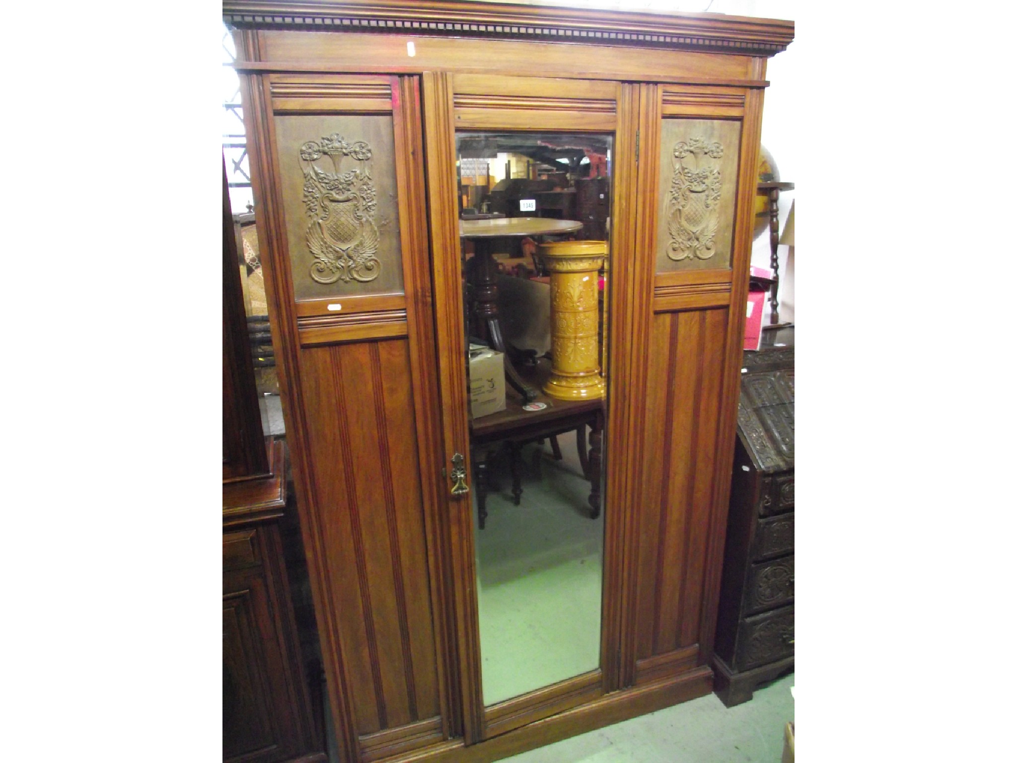 Appraisal: An Edwardian walnut wardrobe with stepped and moulded cornice with