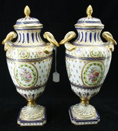 Appraisal: A pair of Sevres type urns and covers enriched with