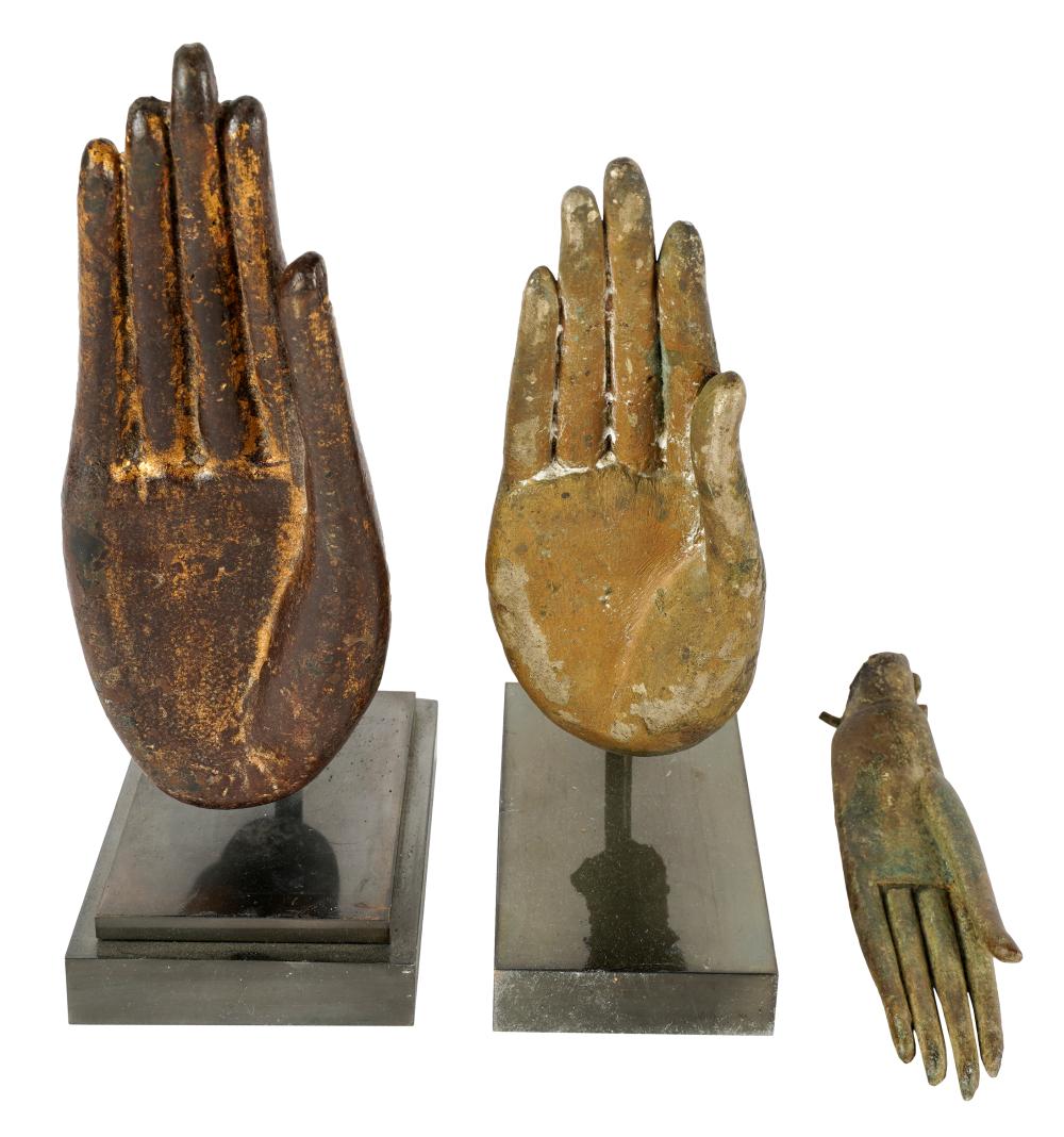 Appraisal: THREE ASIAN BRONZE HANDS OF BUDDHAcomprising two on stand and