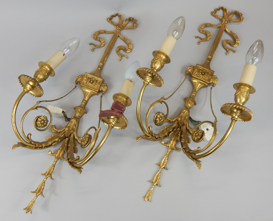 Appraisal: A pair of gilt metal two branch wall lights cast