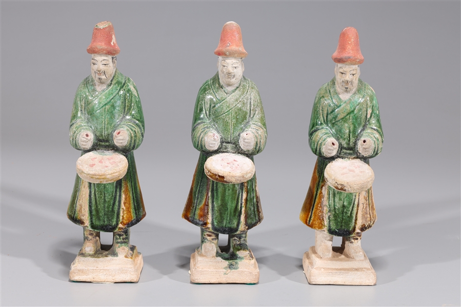 Appraisal: Group of three Chinese green and amber glazed pottery standing