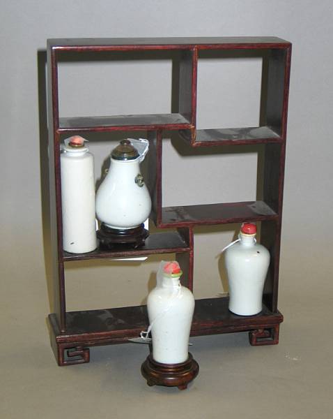 Appraisal: Four white glazed porcelain snuff bottles together with a rectangular