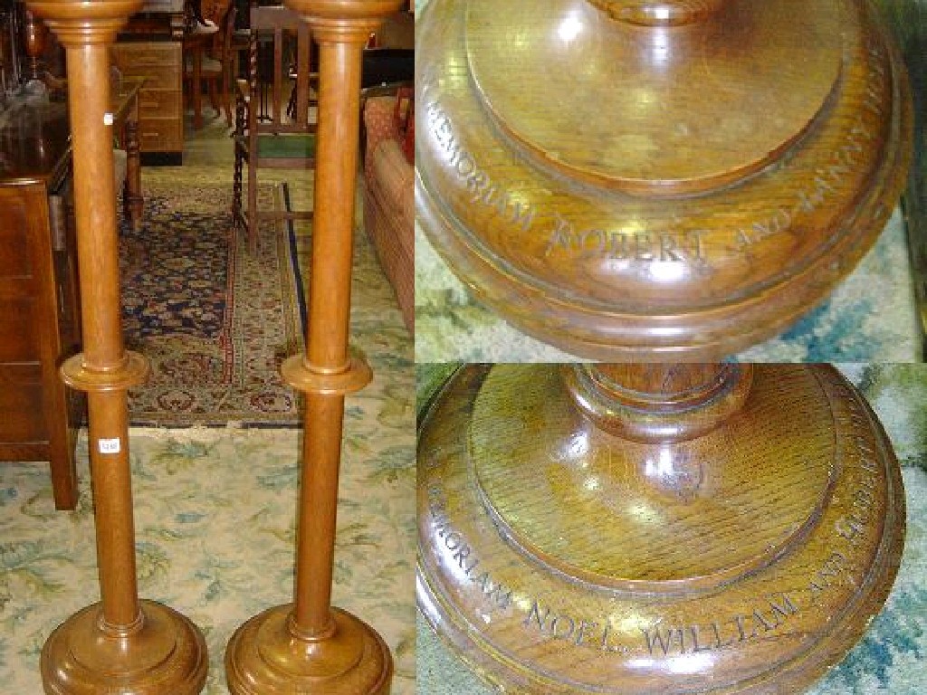 Appraisal: A pair of oak floor standing church candlesticks with simple