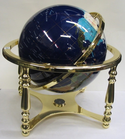 Appraisal: A WORLD GLOBE ON BRASS PLATED HOLDER The countries designated